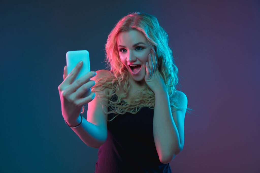 caucasian young woman s portrait gradient background neon light beautiful female model with unusual look concept human emotions facial expression sales ad making selfie bet purchases